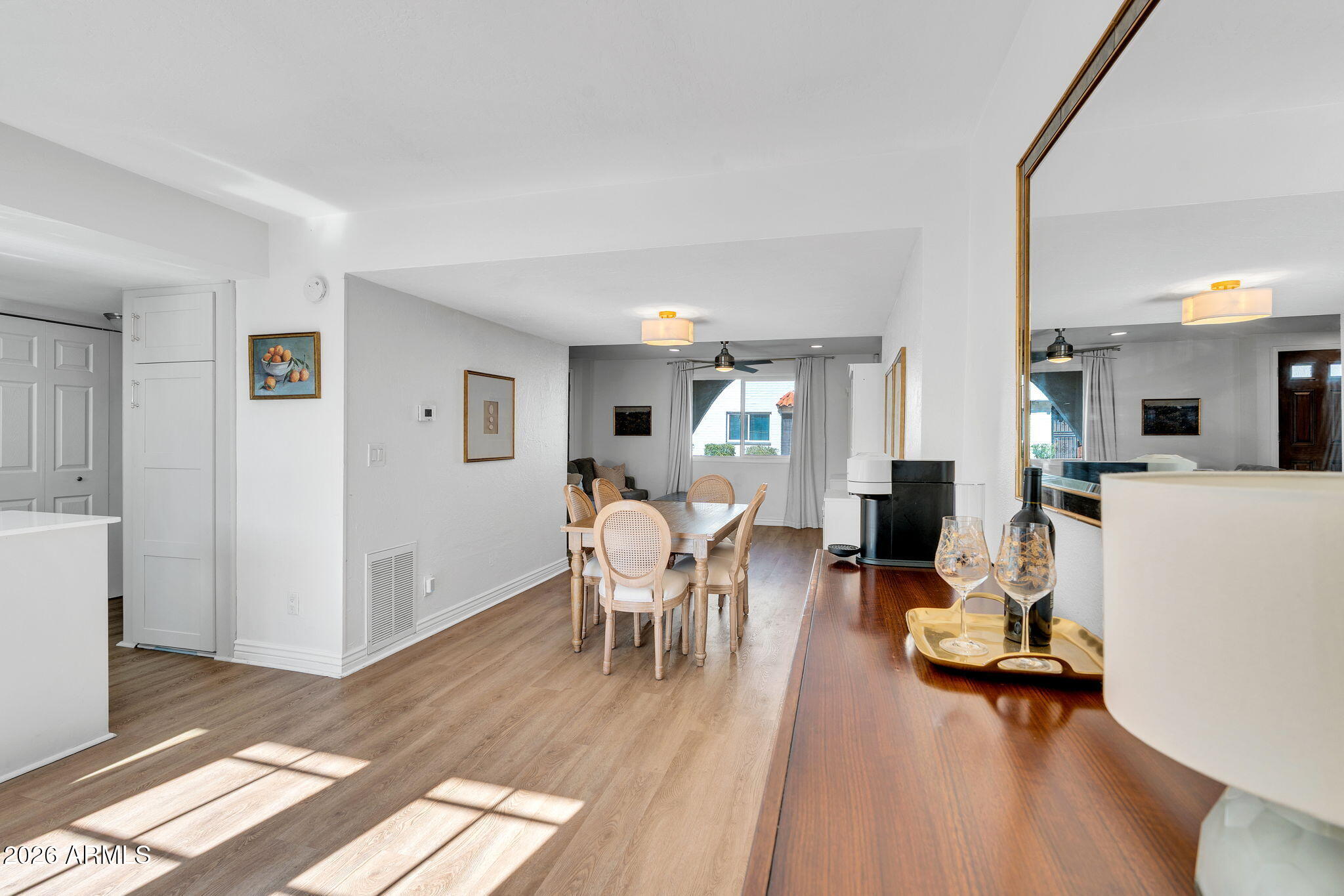 4217 North Miller Road Scottsdale, AZ 85251 - Photo 14 of 30 a view of a livingroom with dining room and wooden floor
