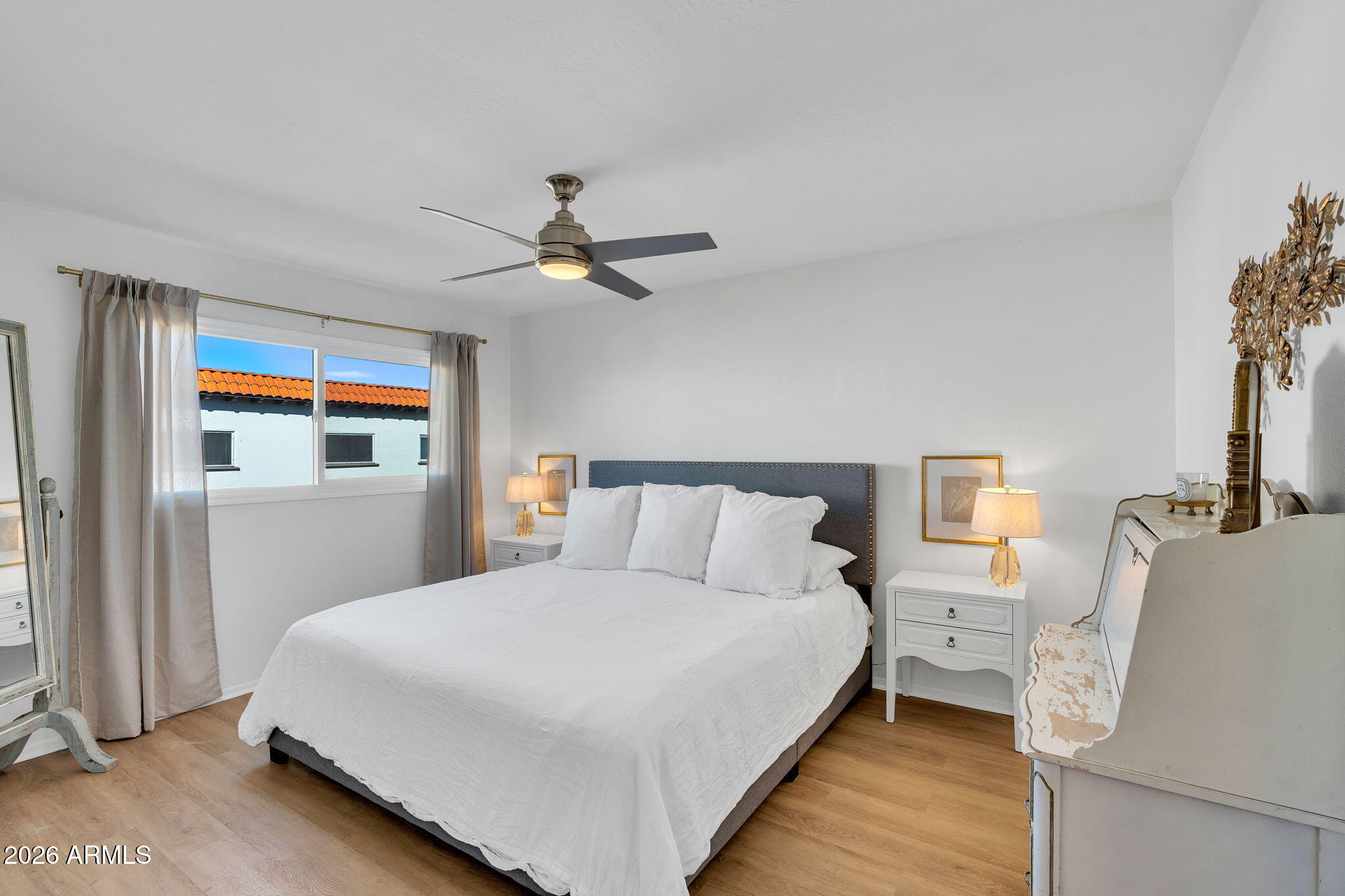 4217 North Miller Road Scottsdale, AZ 85251 - Photo 17 of 30 a bedroom with a large bed and a chandelier