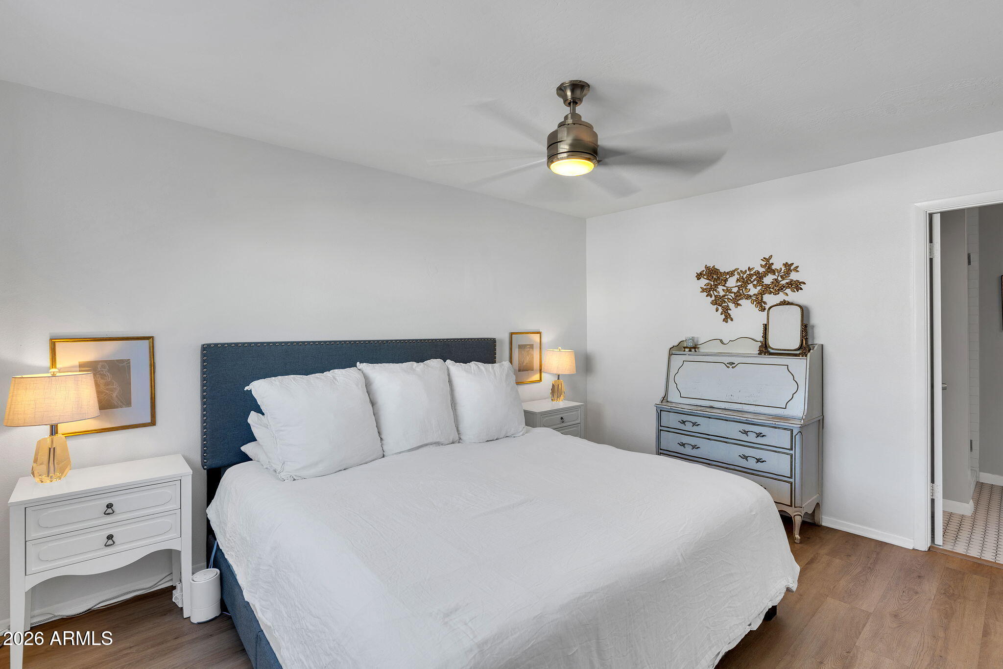 4217 North Miller Road Scottsdale, AZ 85251 - Photo 18 of 30 a bedroom with a bed and painting on the wall
