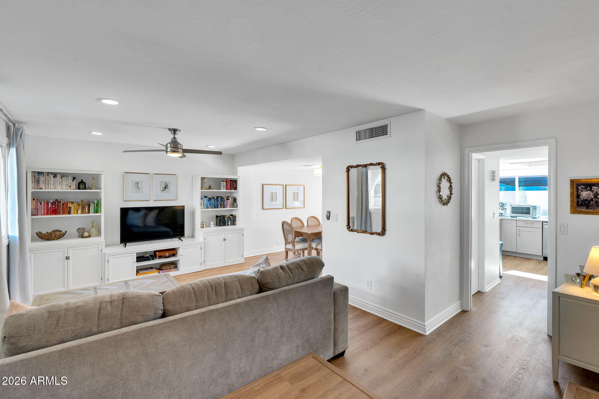 4217 North Miller Road Scottsdale, AZ 85251 - Photo 2 of 30 a living room with furniture and a flat screen tv
