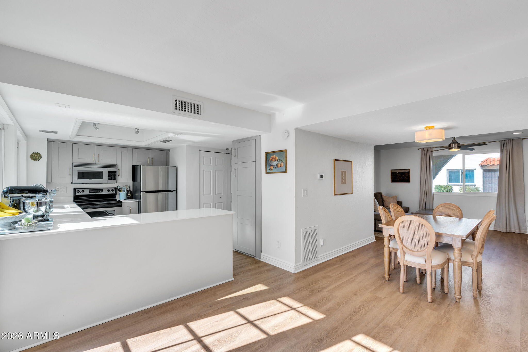4217 North Miller Road Scottsdale, AZ 85251 - Photo 3 of 30 a living room with furniture a flat screen tv and kitchen view