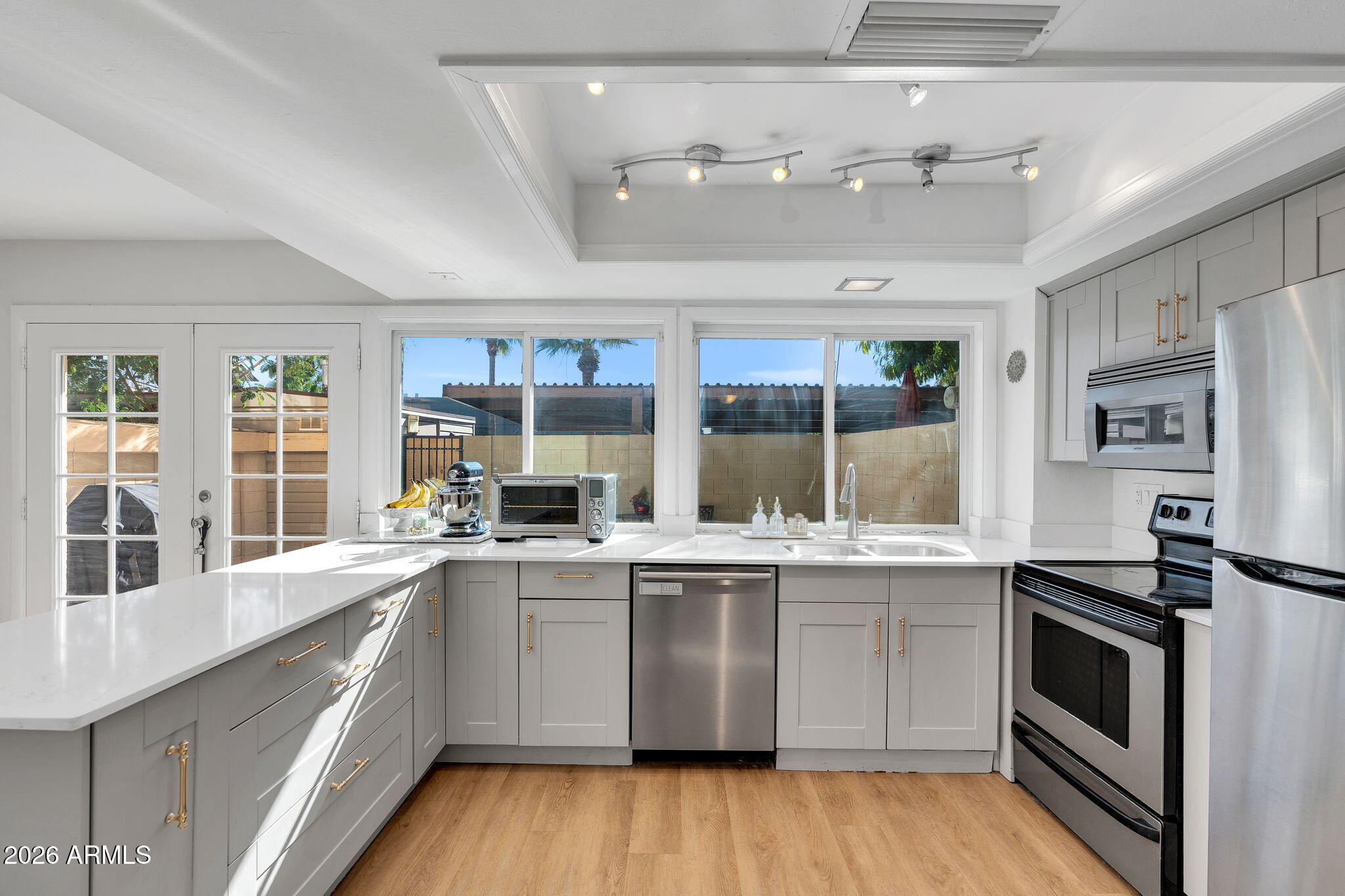 4217 North Miller Road Scottsdale, AZ 85251 - Photo 4 of 30 a kitchen with a sink stove and cabinets