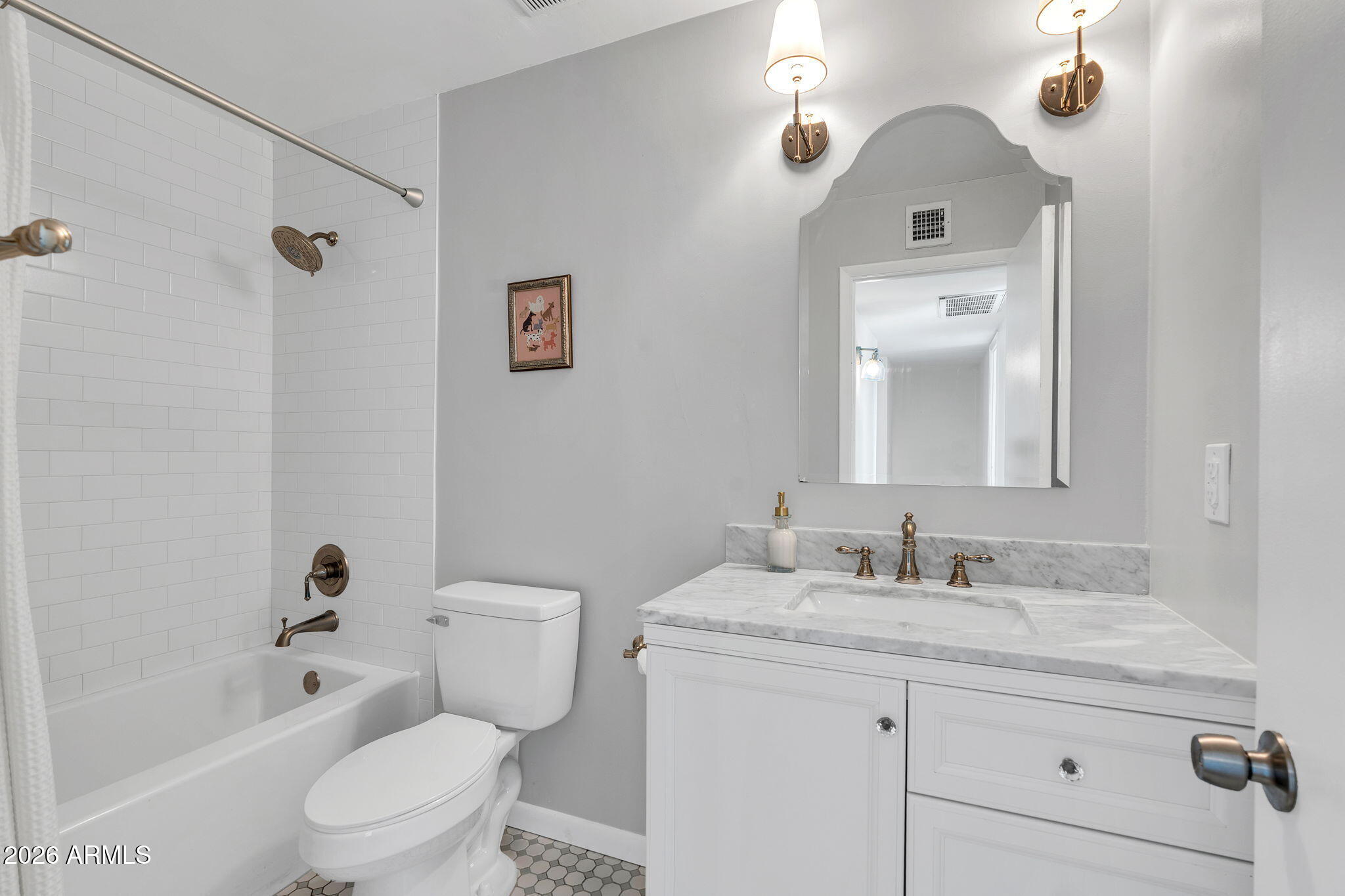4217 North Miller Road Scottsdale, AZ 85251 - Photo 5 of 30 a bathroom with a granite countertop toilet a sink and a bathtub