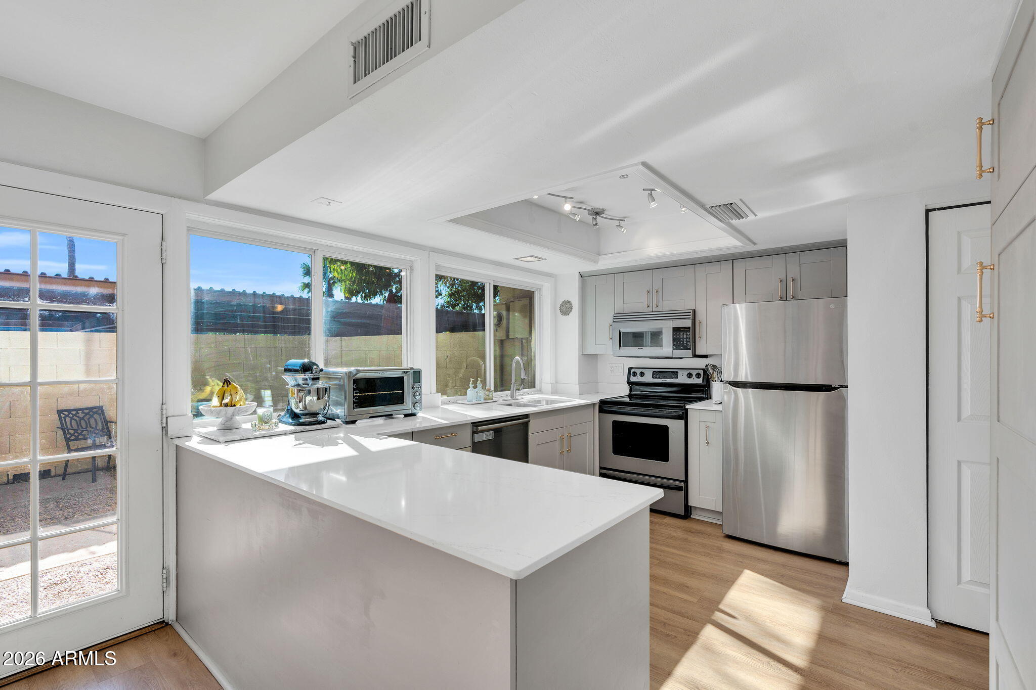 4217 North Miller Road Scottsdale, AZ 85251 - Photo 6 of 30 a kitchen with a stove a sink and a refrigerator