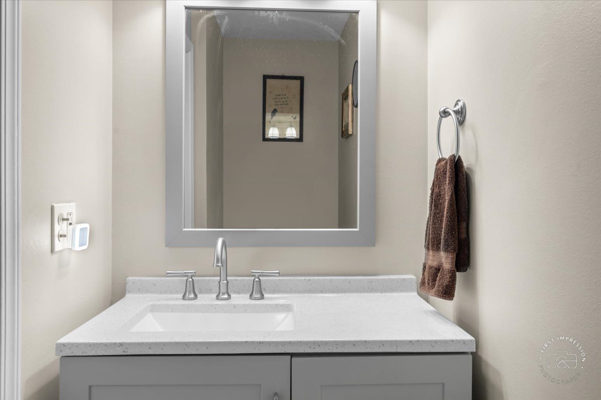 1015 Heathrow Court Wheaton, IL 60189 - Photo 11 of 18 a bathroom with a sink and a mirror