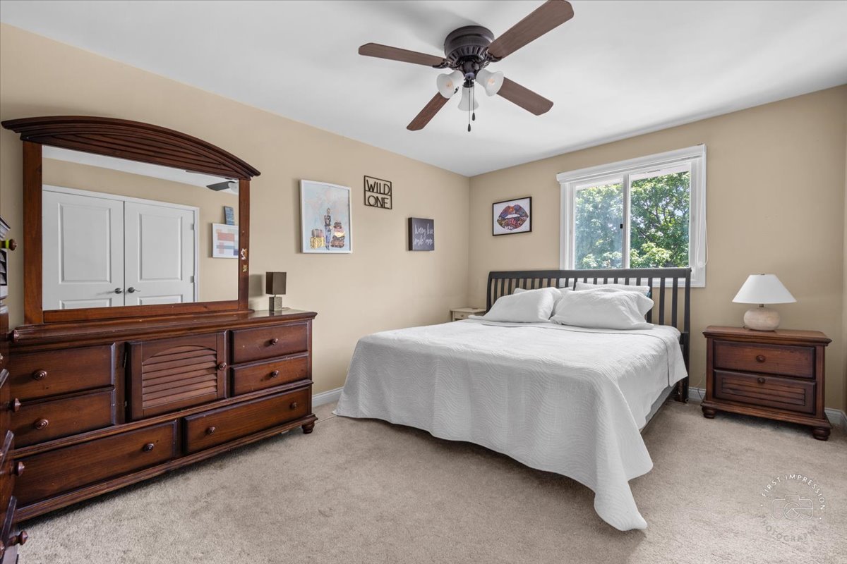1015 Heathrow Court Wheaton, IL 60189 - Photo 13 of 18 a bedroom with a bed and a dresser