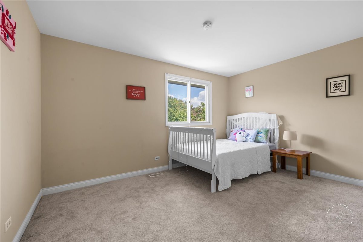 1015 Heathrow Court Wheaton, IL 60189 - Photo 15 of 18 a bed room with a bed and a window