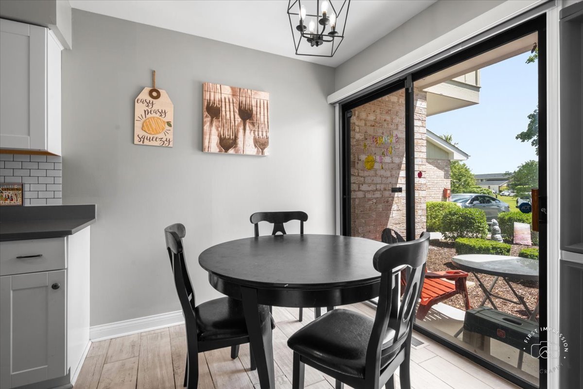 1015 Heathrow Court Wheaton, IL 60189 - Photo 6 of 18 a view of a dining room with furniture window and outside view