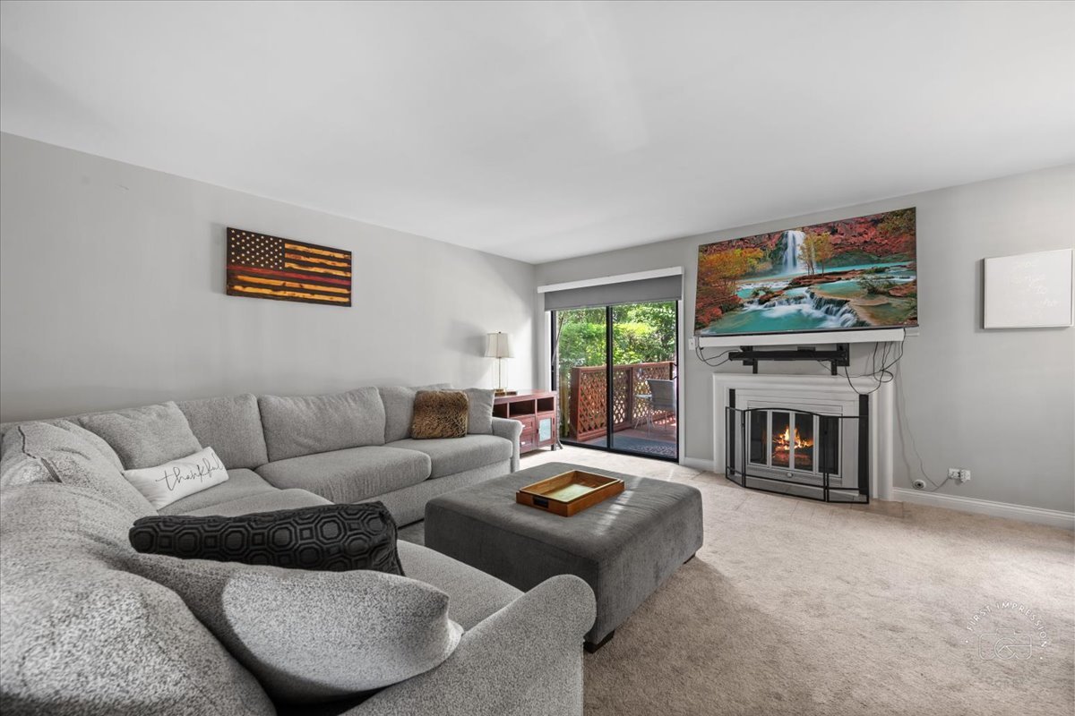 1015 Heathrow Court Wheaton, IL 60189 - Photo 7 of 18 a living room with furniture a fireplace and a flat screen tv