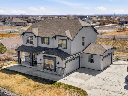 an aerial view of a house with a swimming pool and ocean view
