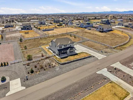 an aerial view of residential houses with outdoor space
