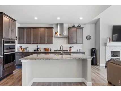 a kitchen with stainless steel appliances granite countertop a sink dishwasher stove top oven and refrigerator