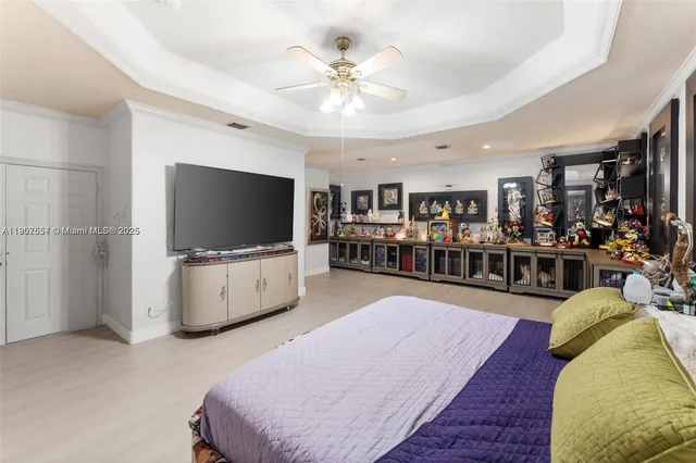 a bedroom with furniture and a flat screen tv