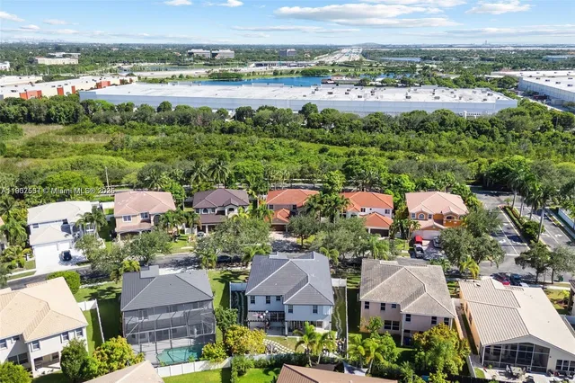 an aerial view of a house with garden space and street view