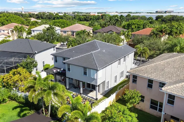 a kitchen with stainless steel appliances kitchen island granite countertop a refrigerator and a sink