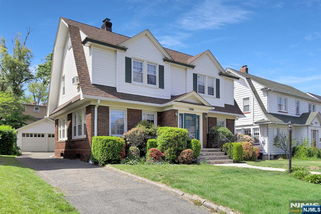 106 Maple Street Rutherford, NJ 07070 - Photo 2 of 50 a front view of a house with a garden