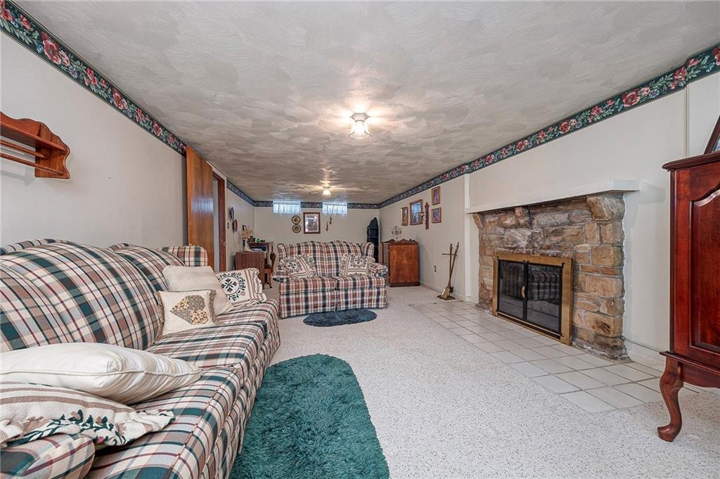 699 Kaye Avenue Monaca, PA 15061 - Photo 22 of 43 a living room with furniture a fireplace and a ceiling fan