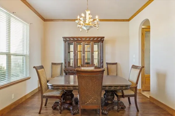 a view of a dining room with furniture and a potted plant