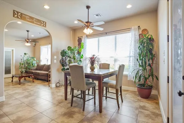 a kitchen with a table chairs sink and cabinets