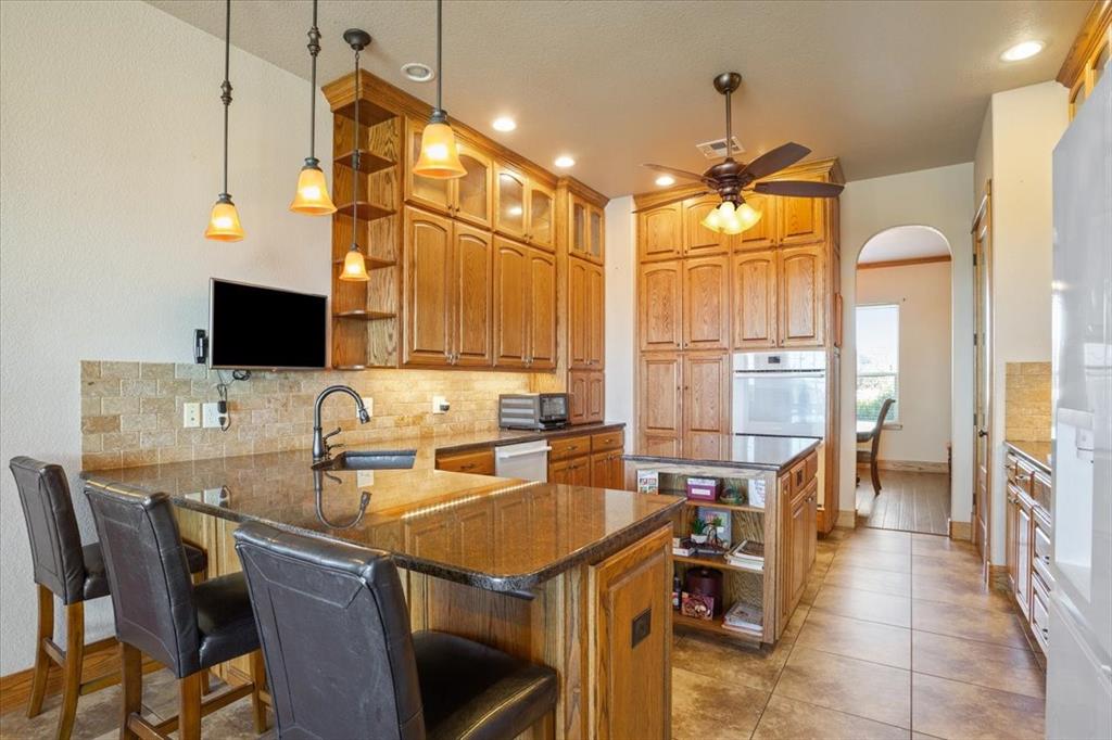 10479 Hartrick Bluff Road Little River-Academy, TX 76554 - Photo 15 of 40 a kitchen with a table chairs sink and cabinets