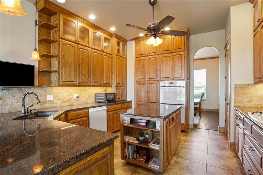 10479 Hartrick Bluff Road Little River-Academy, TX 76554 - Photo 16 of 40 a kitchen with stainless steel appliances granite countertop a sink a stove and a refrigerator