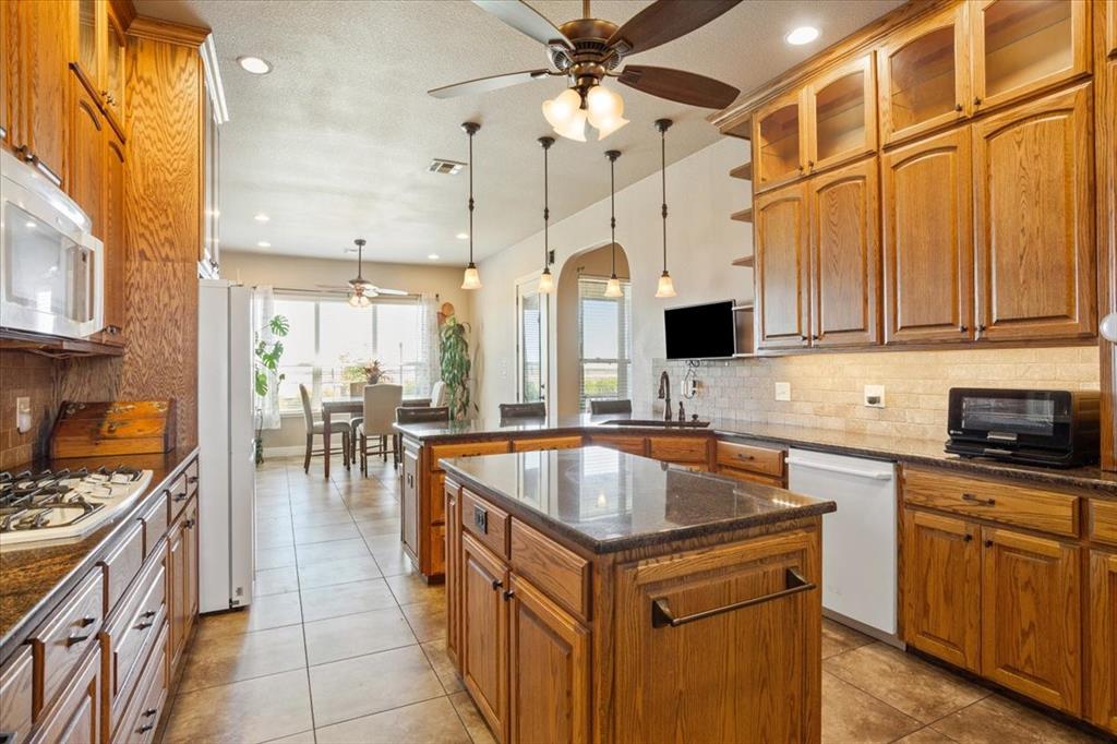10479 Hartrick Bluff Road Little River-Academy, TX 76554 - Photo 17 of 40 a kitchen with granite countertop a sink a counter top space appliances and cabinets