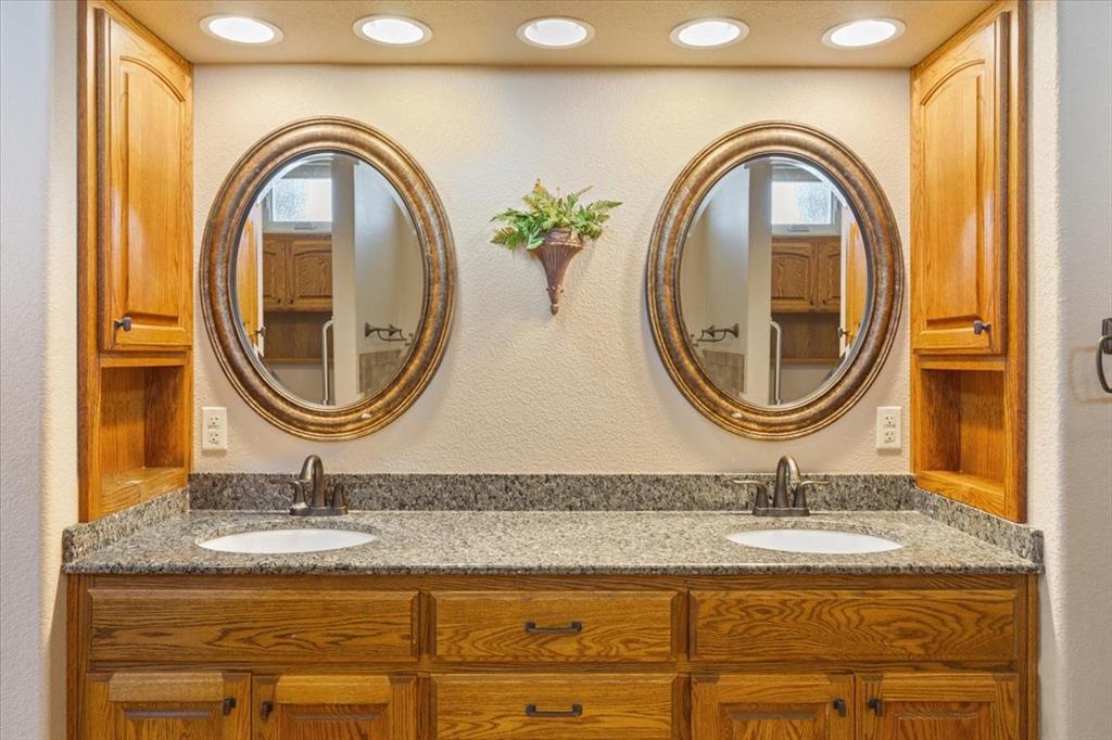 10479 Hartrick Bluff Road Little River-Academy, TX 76554 - Photo 21 of 40 a bathroom with a granite countertop sink and a mirror