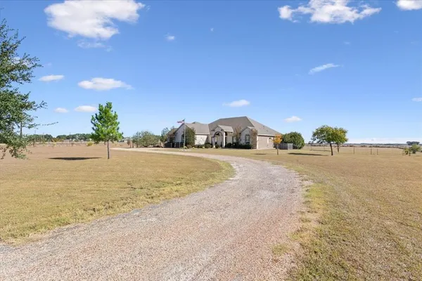 a view of a house with a yard and sitting area