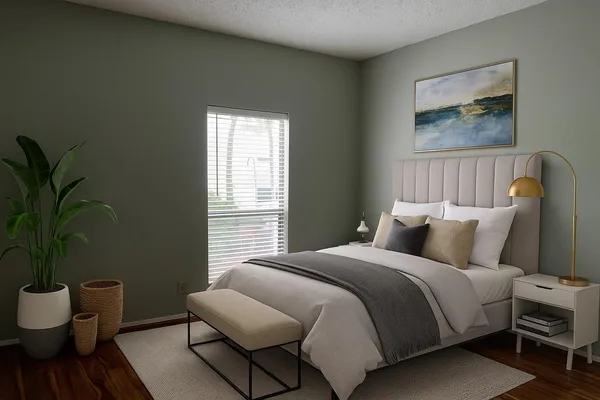 a bedroom with bed and a potted plant