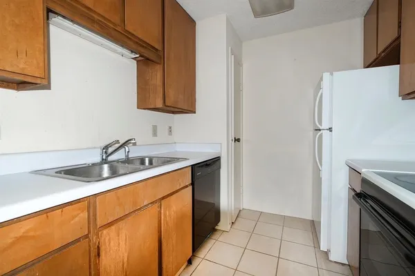 a kitchen with a sink and a refrigerator