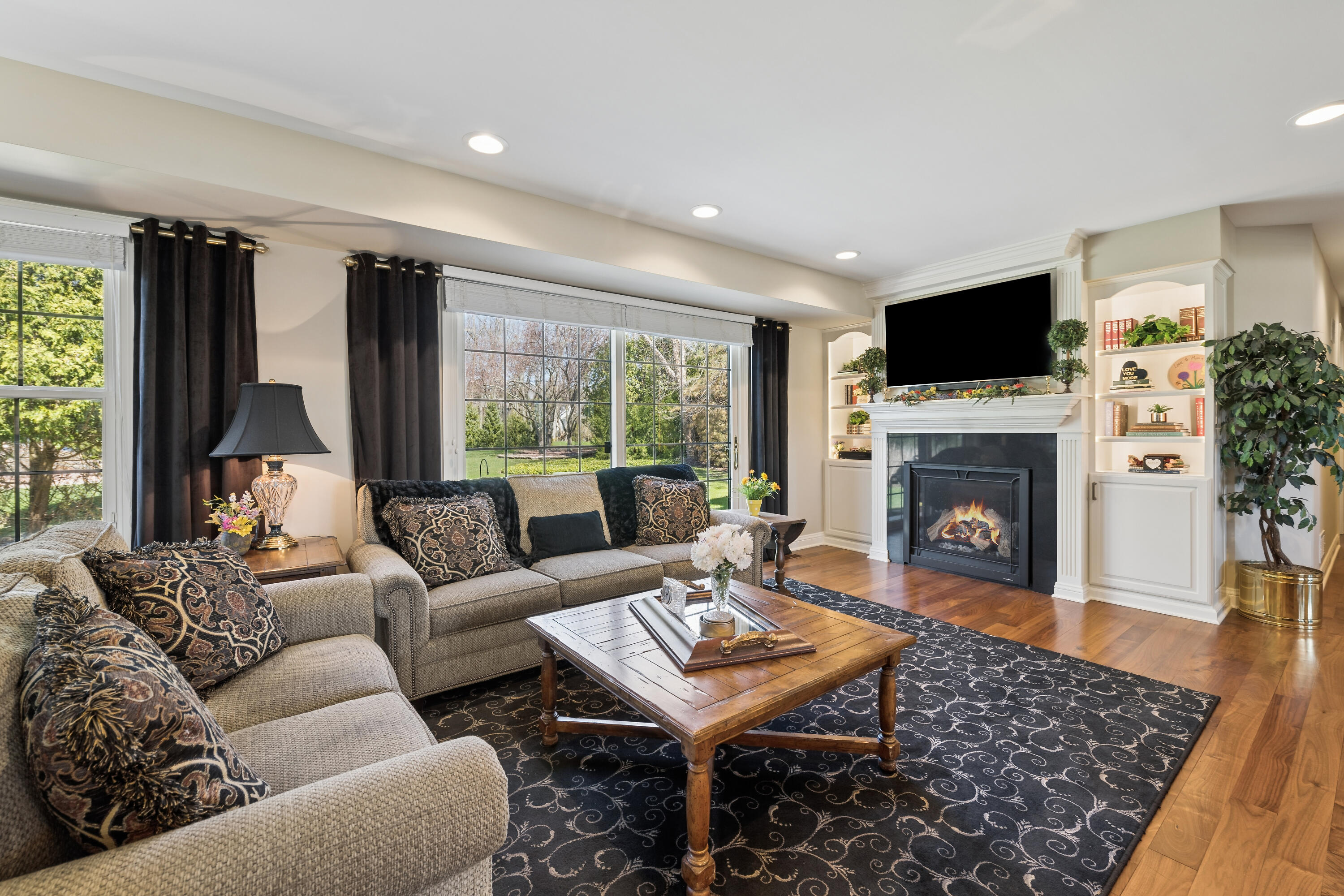 538 Pheasant Ridge Lane Fontana, WI 53125 - Photo 4 of 23 Spacious living room w/FP, built-in bookshelves and patio view