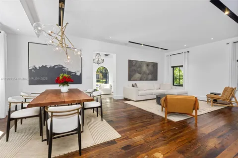 a view of a dining room with furniture wooden floor and chandelier