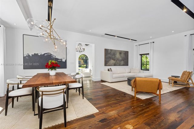 a view of a dining room with furniture wooden floor and chandelier
