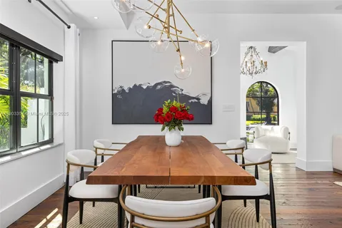 a dining hall with stainless steel appliances granite countertop a stove and a sink with garden view