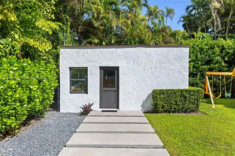 a view of a patio with table and chairs with wooden fence and plants