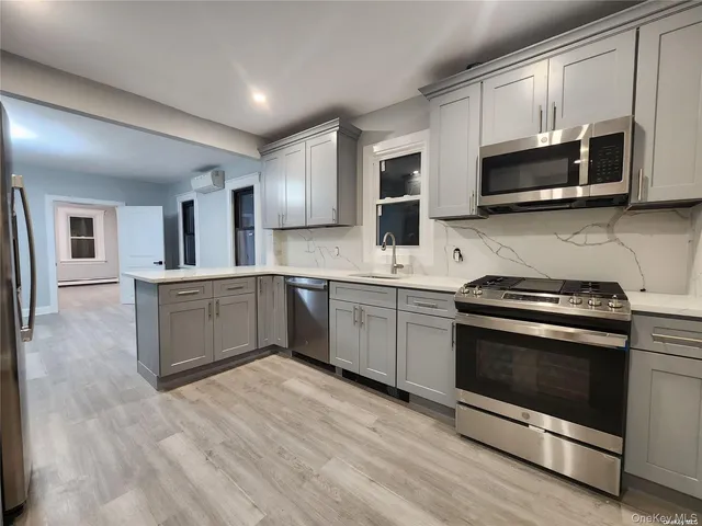 a kitchen with stainless steel appliances granite countertop a stove top oven and sink