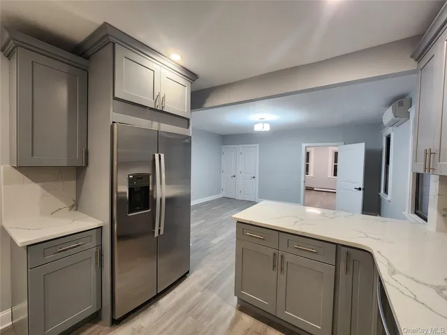 a kitchen with a refrigerator and a sink