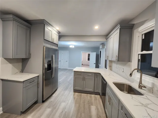a kitchen with a sink stove and refrigerator