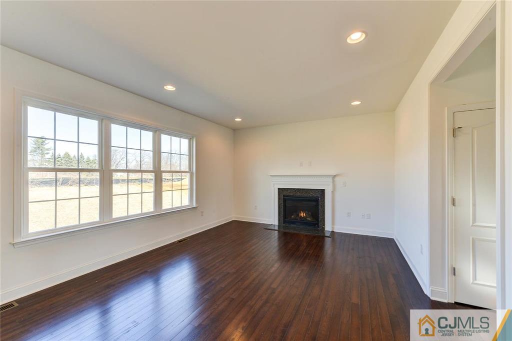 10 May Road East Brunswick, NJ 08816 - Photo 11 of 24 an empty room with wooden floor and windows