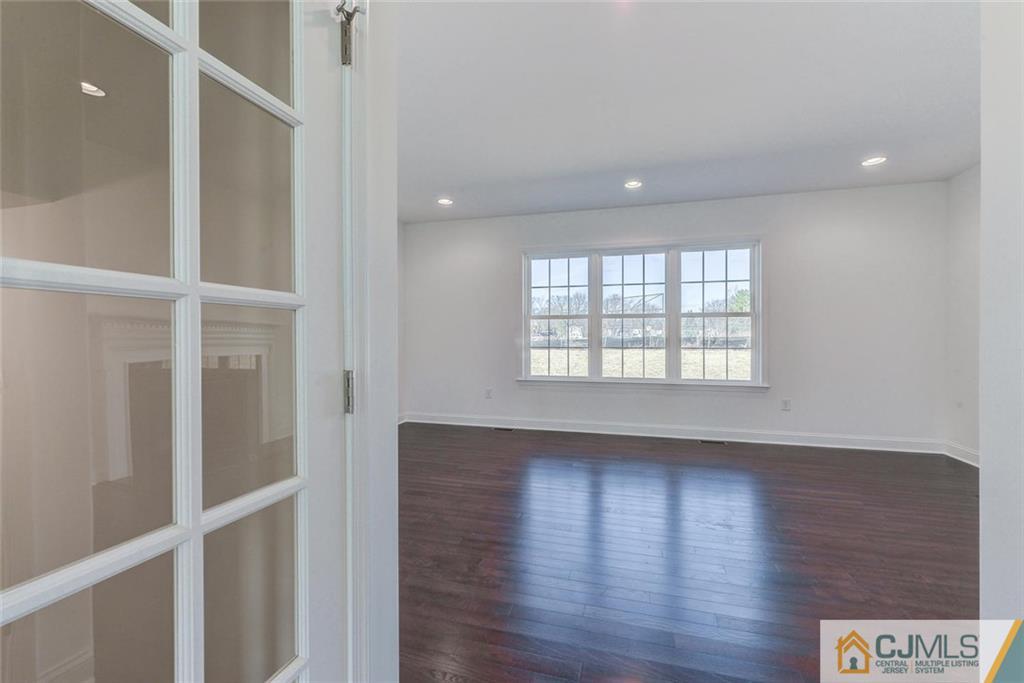 10 May Road East Brunswick, NJ 08816 - Photo 12 of 24 a view of an empty room with wooden floor and a window
