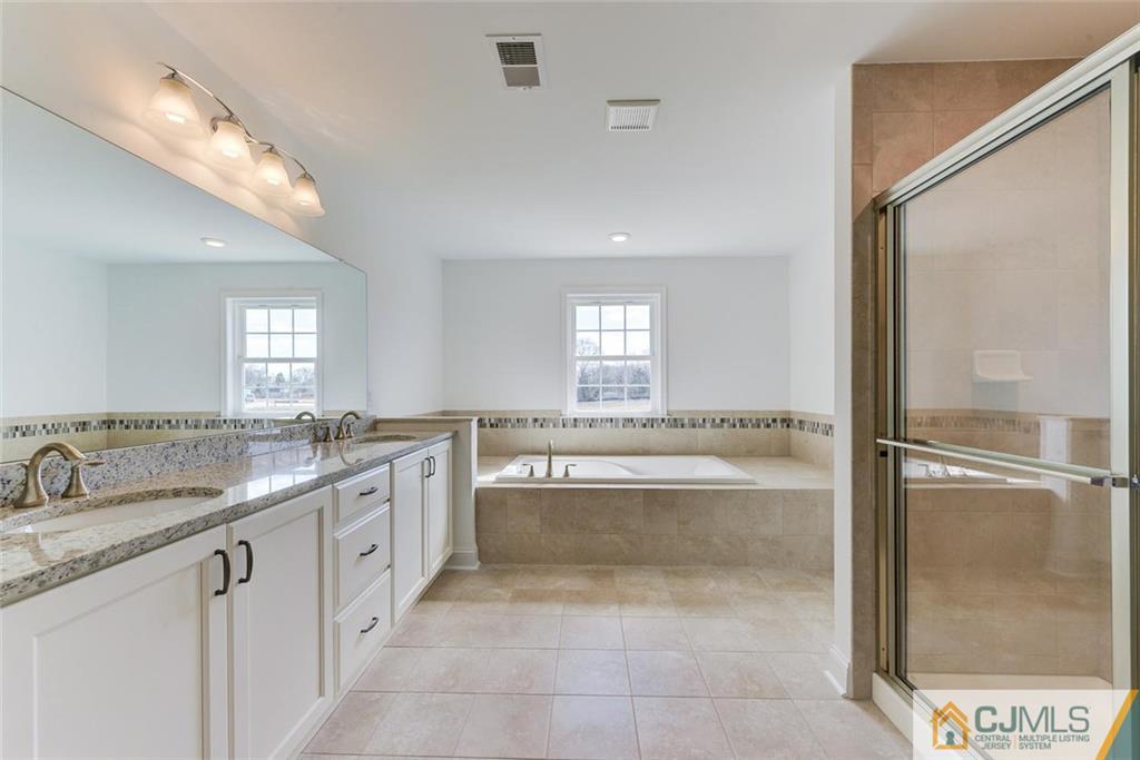 10 May Road East Brunswick, NJ 08816 - Photo 14 of 24 a bathroom with a granite countertop tub sink and mirror