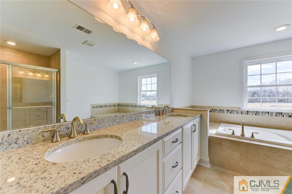 10 May Road East Brunswick, NJ 08816 - Photo 16 of 24 a bathroom with a granite countertop sink and a large mirror