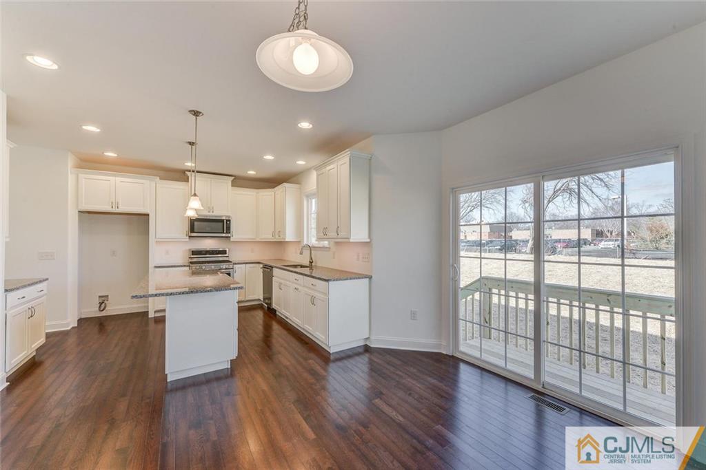 10 May Road East Brunswick, NJ 08816 - Photo 7 of 24 a large kitchen with cabinets wooden floor and stainless steel appliances