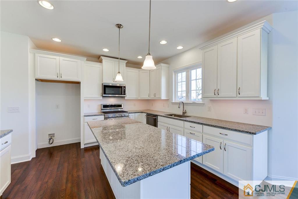 10 May Road East Brunswick, NJ 08816 - Photo 8 of 24 a kitchen with stainless steel appliances granite countertop a sink a stove and a wooden floors