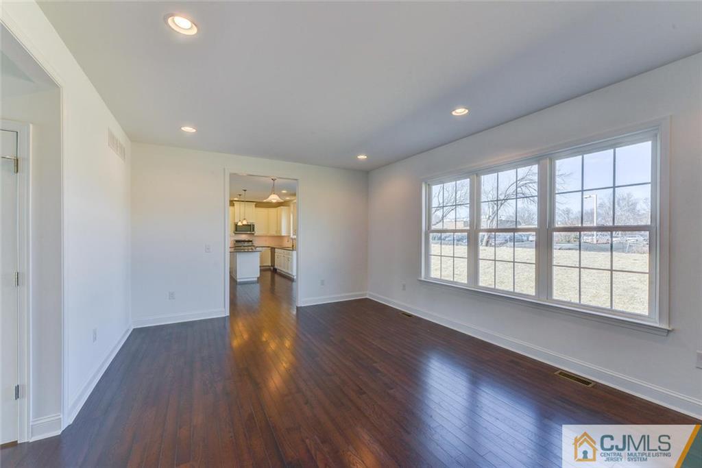 10 May Road East Brunswick, NJ 08816 - Photo 10 of 24 a view of an empty room with wooden floor and a window
