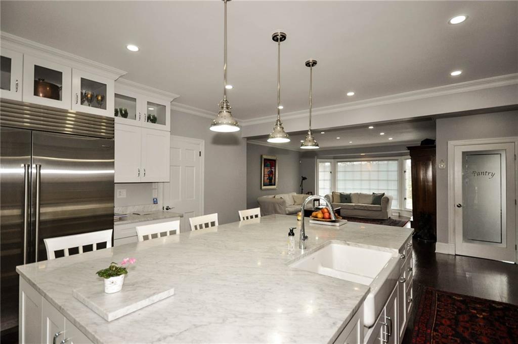 815 Fox Chapel Road Fox Chapel, PA 15238 - Photo 8 of 25 Top of the line kitchen features this carrara marble island with lots of seating space around it and a sub zero refrigerator and a large Wolf gas range+ many cabinets for all of your storage needs. A large walk in pantry is fuly organized to store everything. The garage interior door opens into the kitchen.