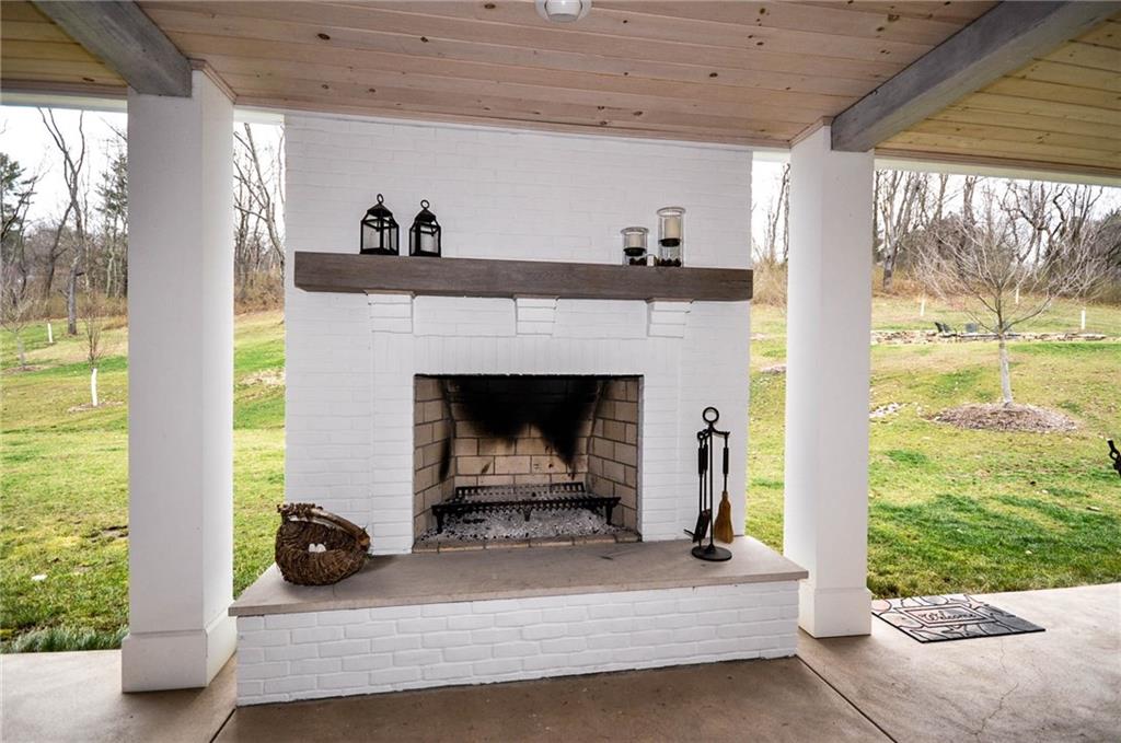 815 Fox Chapel Road Fox Chapel, PA 15238 - Photo 10 of 25 The covered patio, across the back of the home, features a log burning fireplace to take the edge off of the cooler evening temperatures.