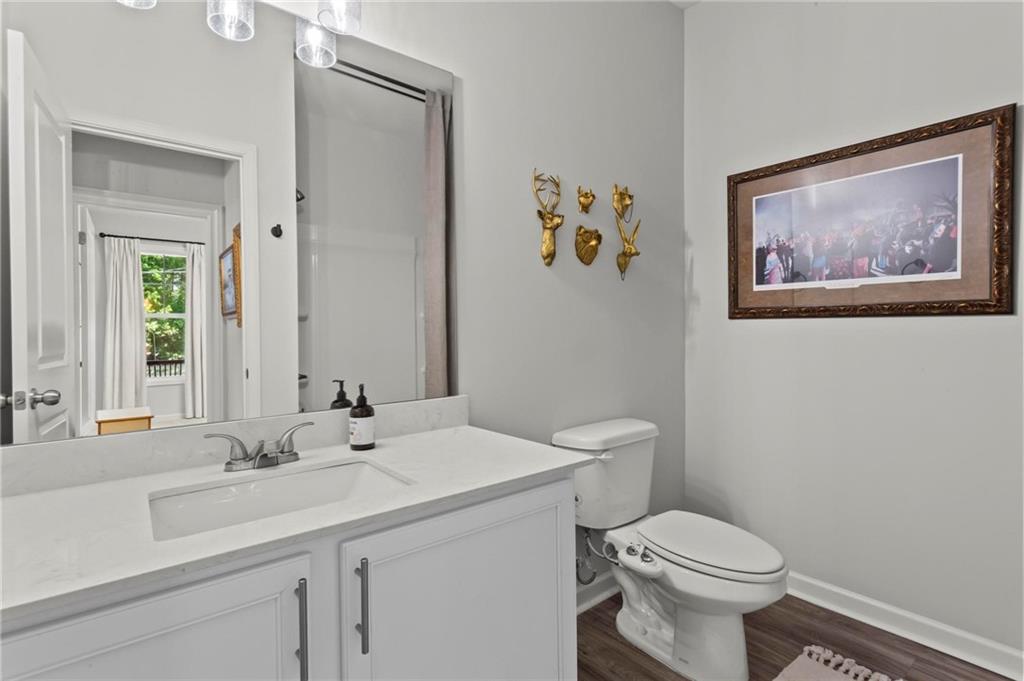 2081 Nunnally Farm Road Monroe, GA 30655 - Photo 25 of 44 a bathroom with a toilet a sink and mirror