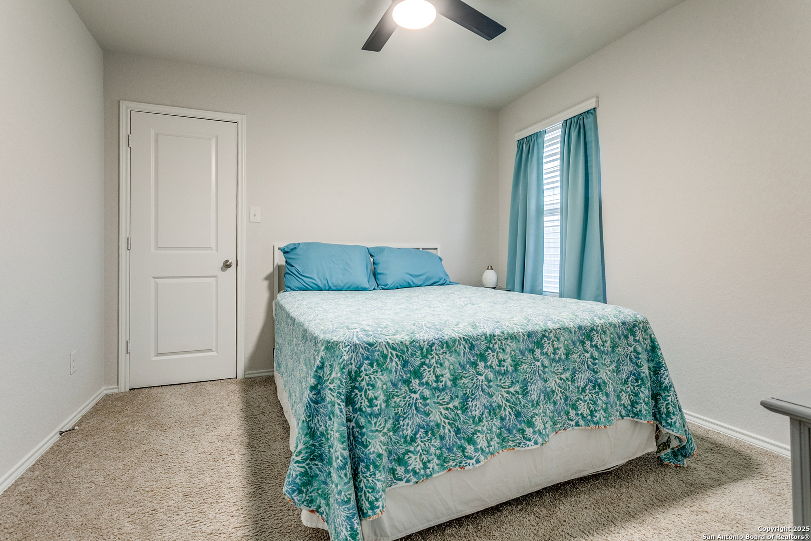 29632 Winter Copper Bulverde, TX 78163 - Photo 19 of 26 a bedroom with a bed and a chandelier fan