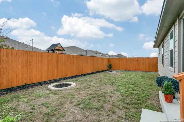 a backyard of a house with table and chairs